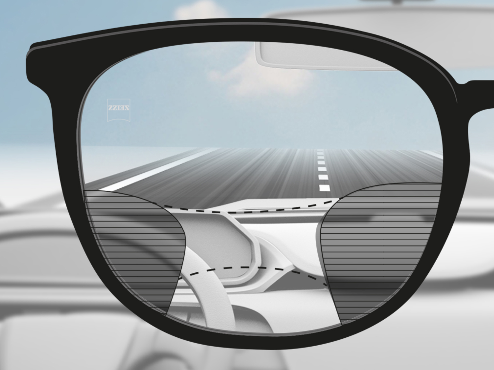 En perspektivbild genom ett ZEISS Progressive DriveSafe-glas: synzonerna är anpassade så att föraren har klara synzoner på vägen och instrumentbrädan.