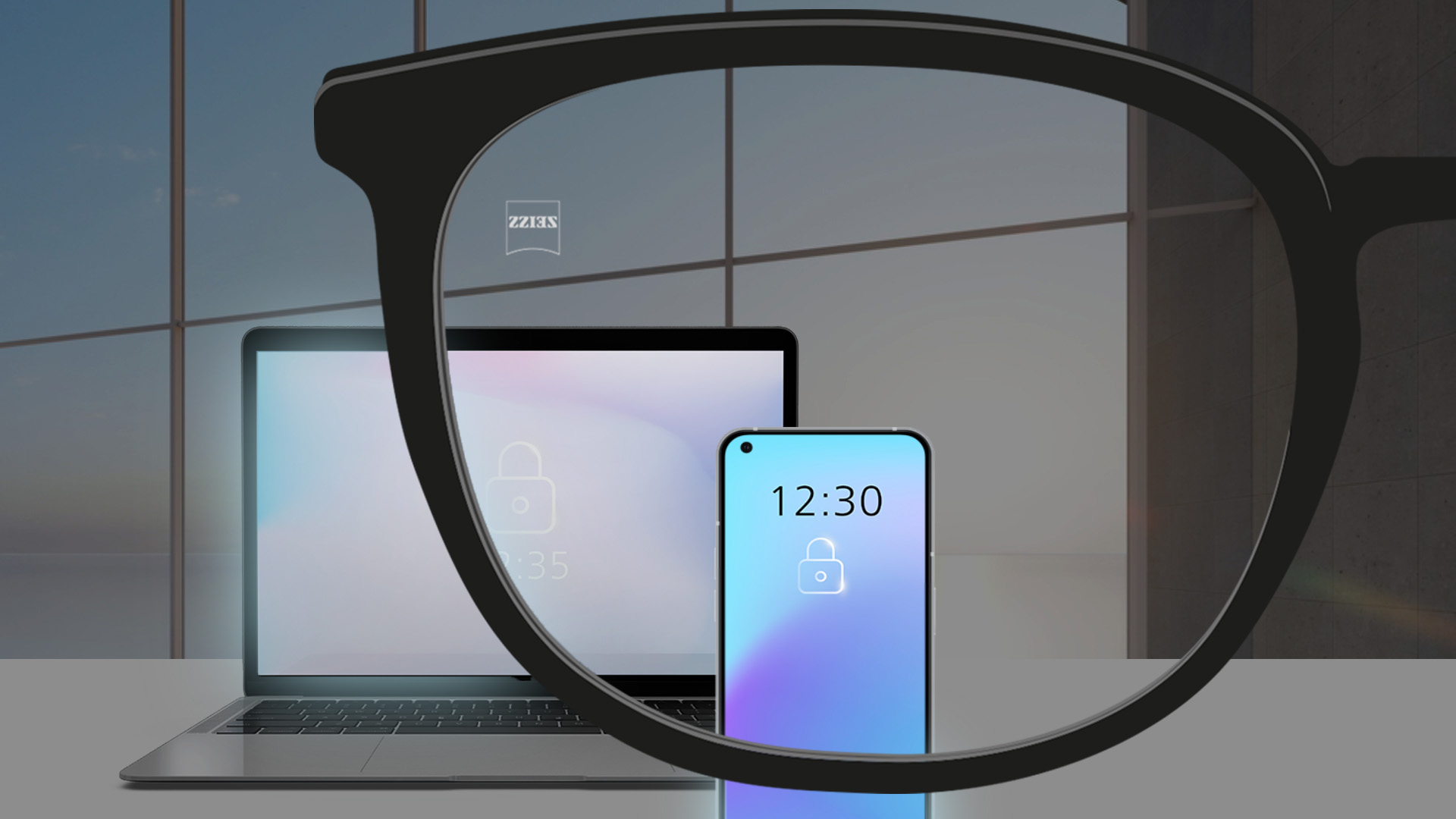 En perspektivbild med en bärbar dator och en smartphone i ett rum med dimmad belysning.